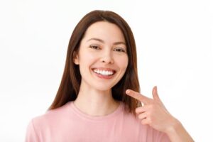 a woman pointing at her beaming smile