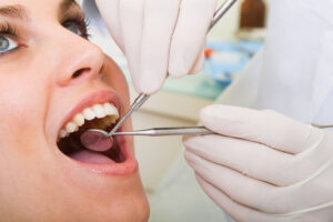 a woman being examined by her dentist
