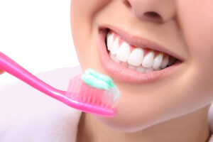 Close-up of woman brushing her beautiful white teeth