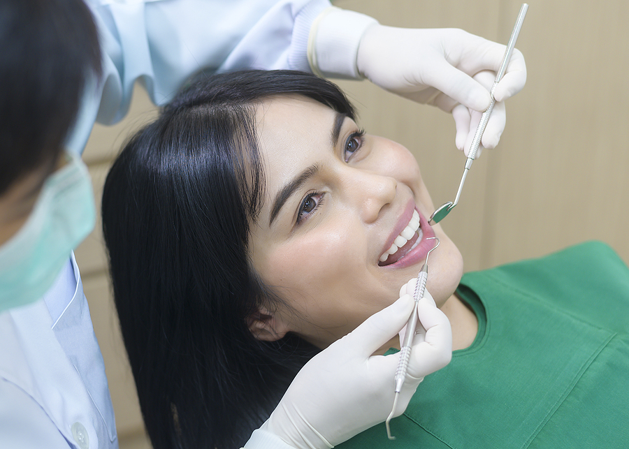 Young Woman Having Teeth Examined By Dentist In Dental Clinic, T