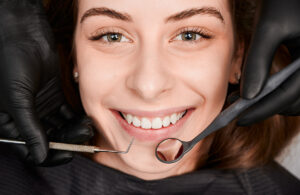 Smiling young woman receiving dental care