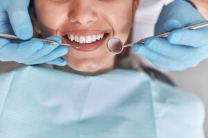 Smiling woman having dental exam performed by a dentist
